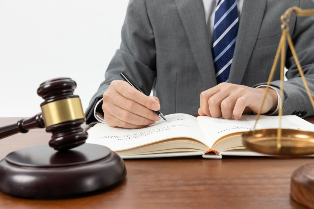 <a href="https://www.freepik.com/free-photo/closeup-shot-person-writing-book-with-gavel-table_25928542.htm?log-in=google">Image by wirestock</a> on Freepik